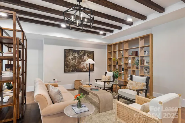 a living room with furniture and view of kitchen