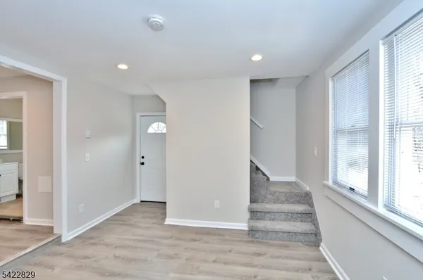 a view of entryway with wooden floor and stairs