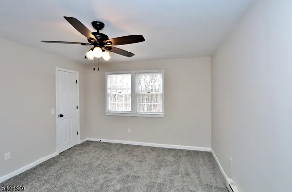 a view of an empty room with a ceiling fan