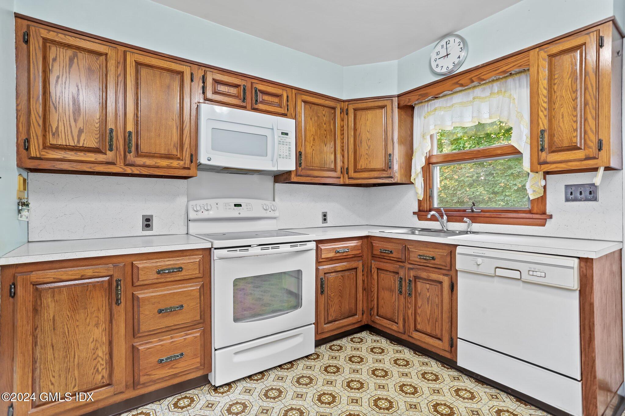 20 Norias Road Greenwich, CT 06830 - Photo 11 of 40 a kitchen with stainless steel appliances granite countertop a stove a sink dishwasher and cabinets with wooden floor