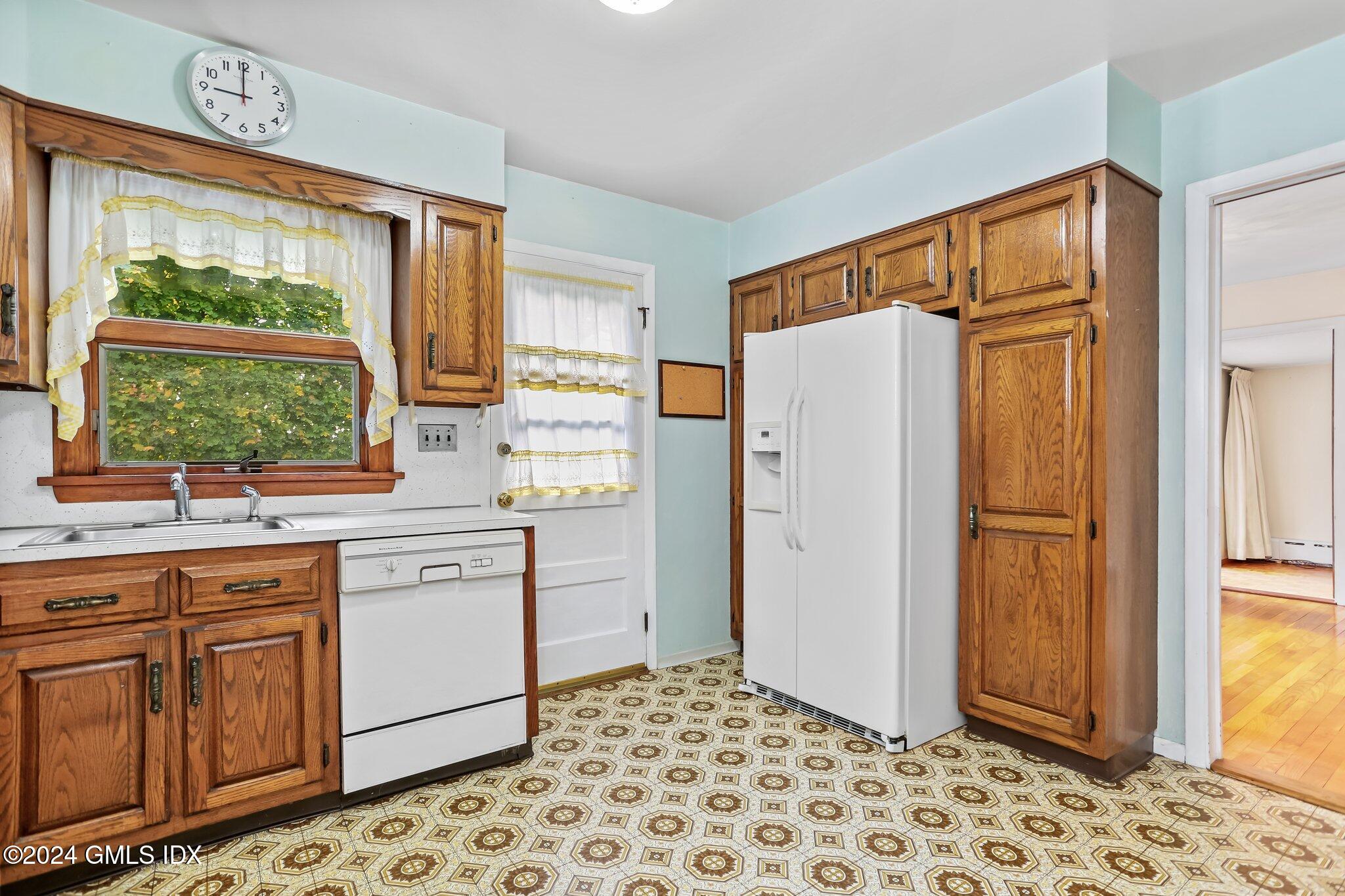 20 Norias Road Greenwich, CT 06830 - Photo 12 of 40 a kitchen with stainless steel appliances a refrigerator sink and cabinets