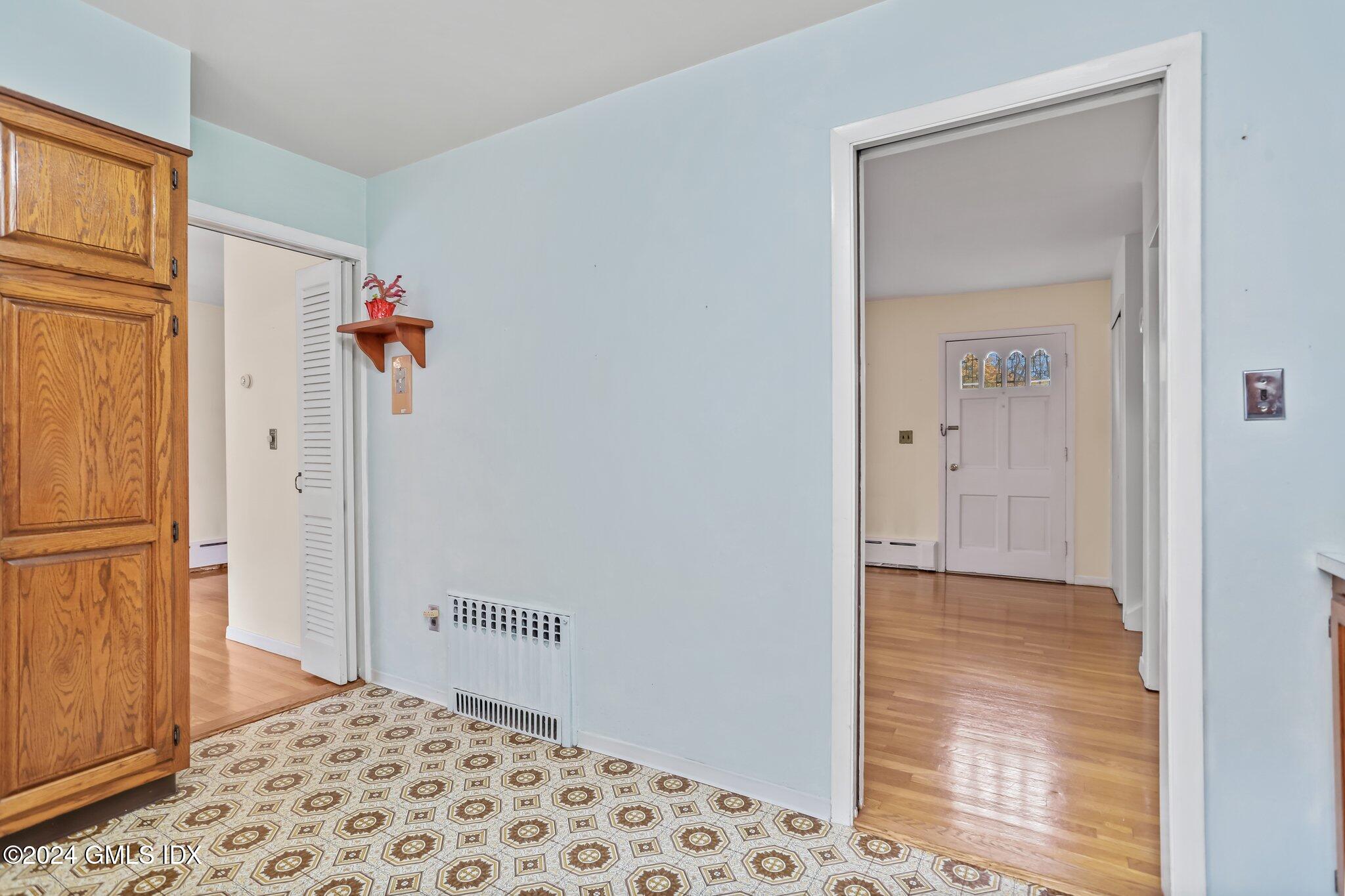 20 Norias Road Greenwich, CT 06830 - Photo 13 of 40 a view of a hallway with a bedroom and wooden floor