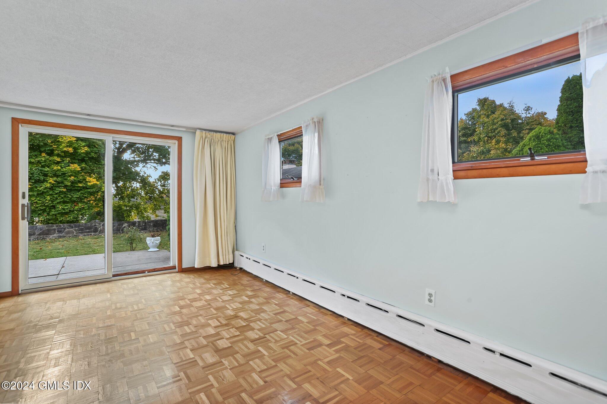 20 Norias Road Greenwich, CT 06830 - Photo 15 of 40 a view of an empty room with wooden floor and a window