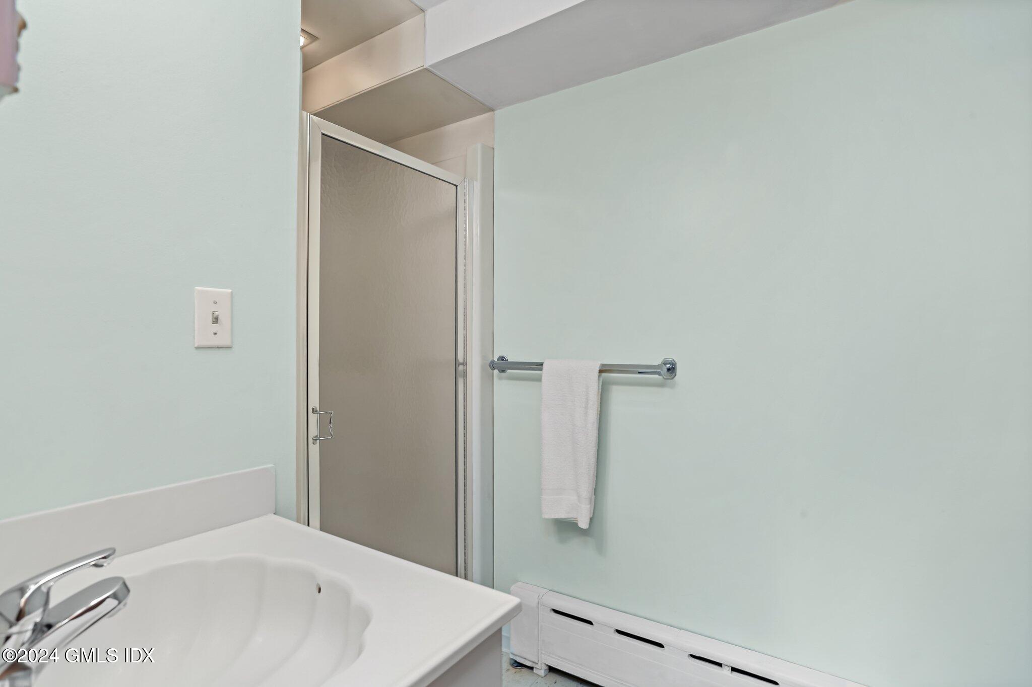 20 Norias Road Greenwich, CT 06830 - Photo 16 of 40 a bathroom with a sink and shower