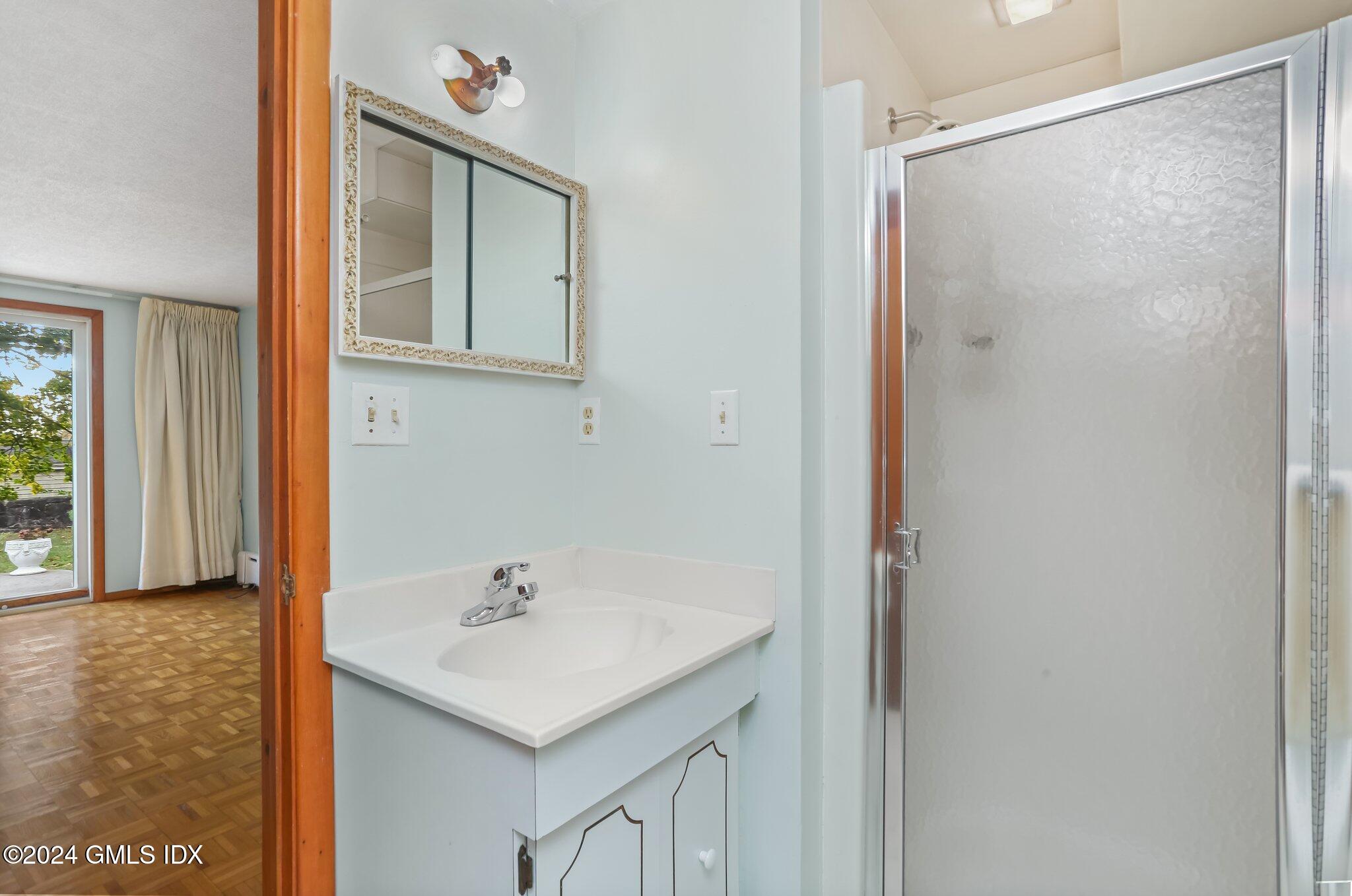 20 Norias Road Greenwich, CT 06830 - Photo 17 of 40 a bathroom with a shower sink and mirror