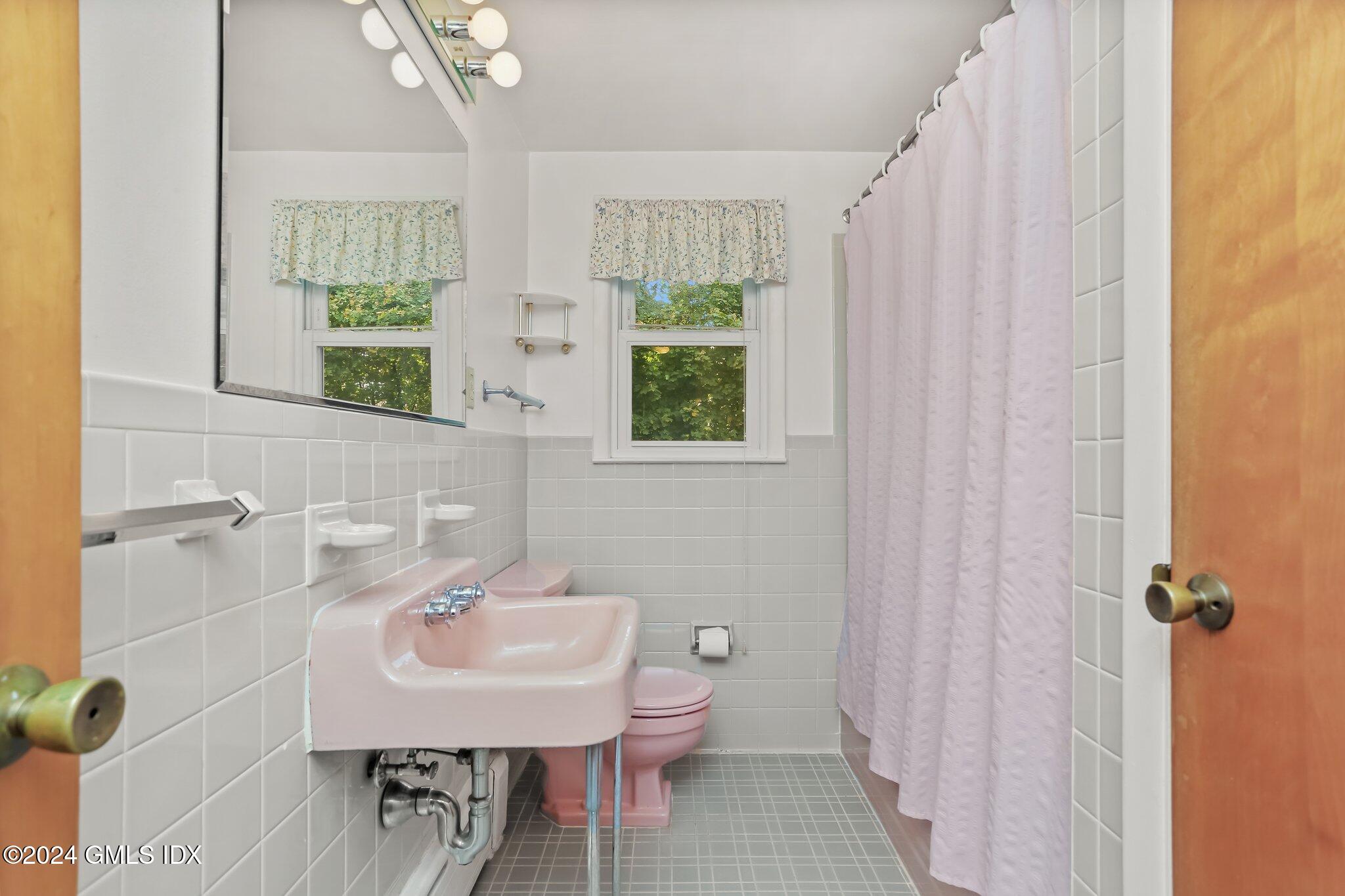 20 Norias Road Greenwich, CT 06830 - Photo 22 of 40 a bathroom with a sink a toilet and shower curtain