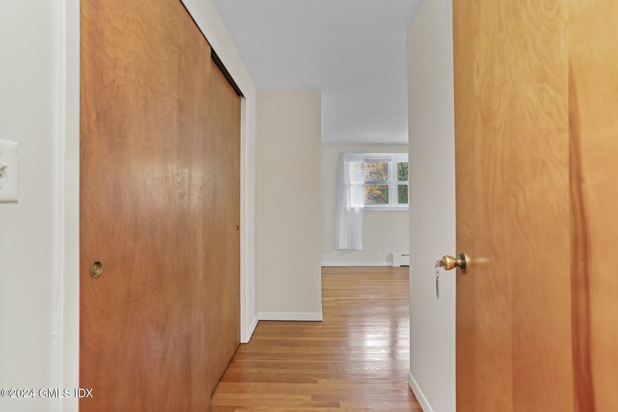 20 Norias Road Greenwich, CT 06830 - Photo 23 of 40 a view of a hallway with wooden floor and closet