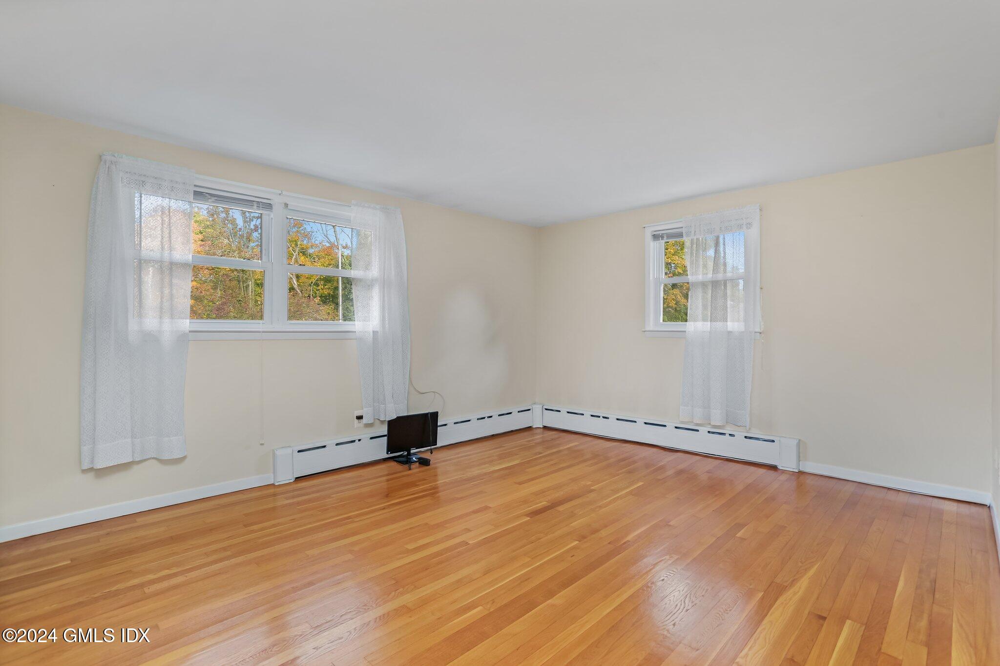 20 Norias Road Greenwich, CT 06830 - Photo 24 of 40 a view of an empty room with wooden floor and a window