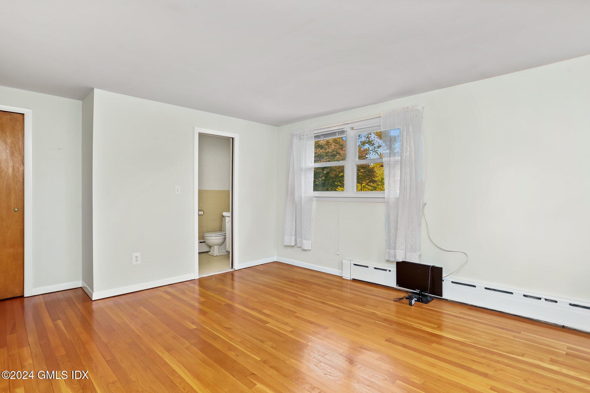 20 Norias Road Greenwich, CT 06830 - Photo 25 of 40 a view of empty room with wooden floor and fan