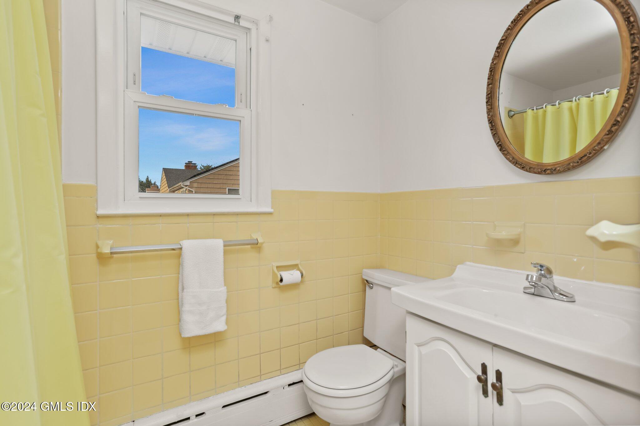 20 Norias Road Greenwich, CT 06830 - Photo 26 of 40 a bathroom with a sink mirror and toilet