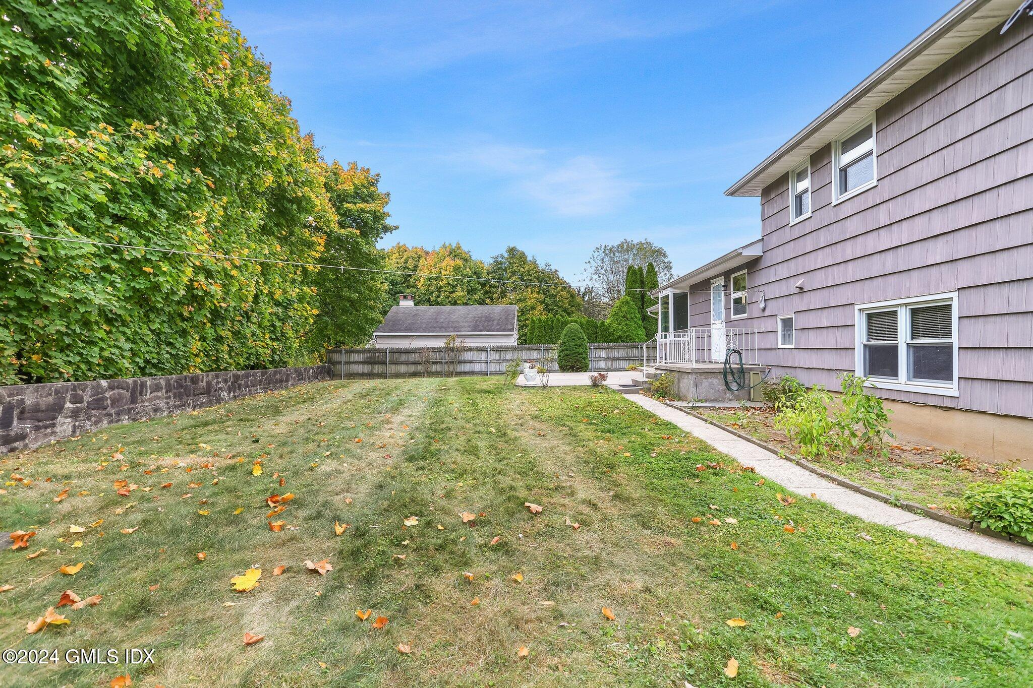 20 Norias Road Greenwich, CT 06830 - Photo 34 of 40 a view of a backyard with plants and large trees