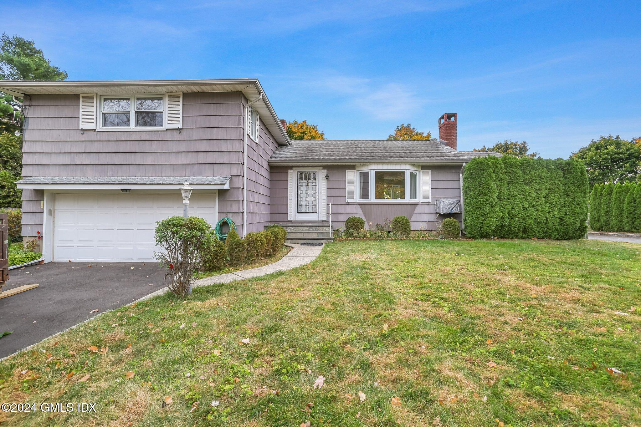 20 Norias Road Greenwich, CT 06830 - Photo 39 of 40 a front view of a house with a yard