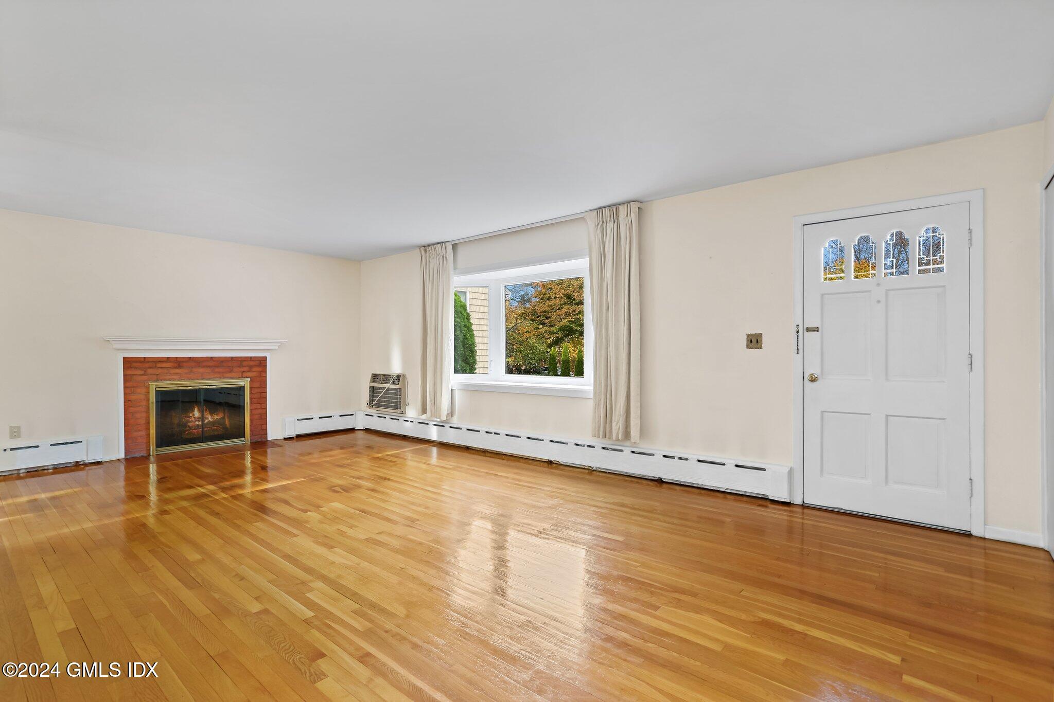 20 Norias Road Greenwich, CT 06830 - Photo 4 of 40 a view of an empty room with wooden floor and a window