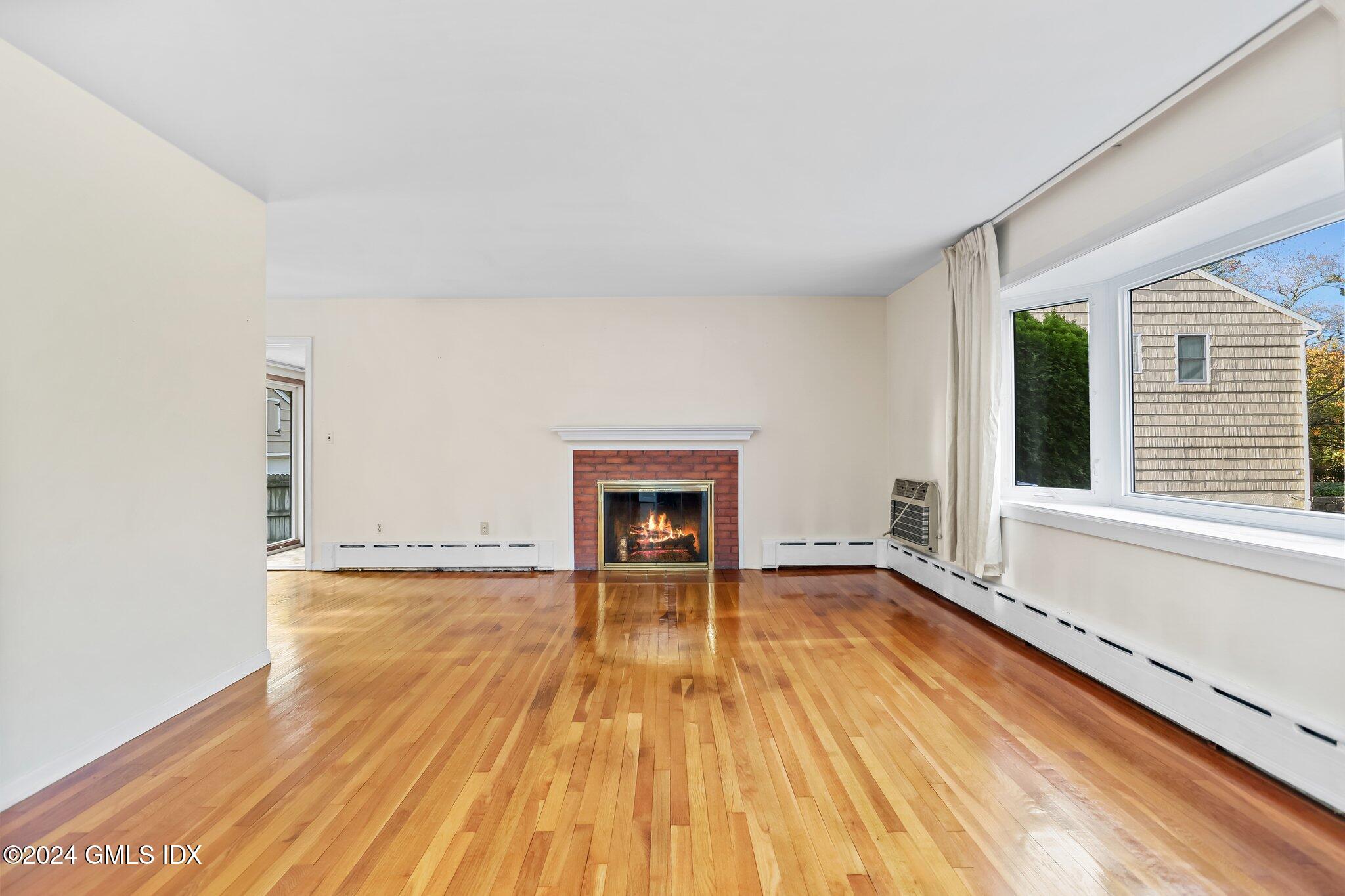 20 Norias Road Greenwich, CT 06830 - Photo 5 of 40 a view of an empty room with wooden floor and a window