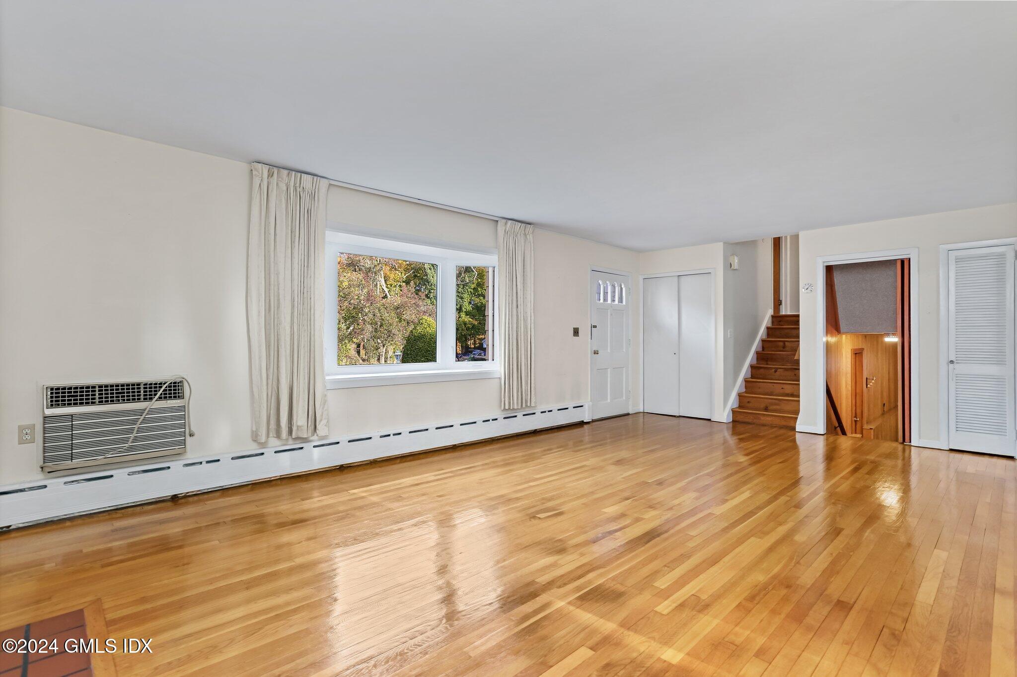 20 Norias Road Greenwich, CT 06830 - Photo 6 of 40 a view of an empty room with wooden floor and a window