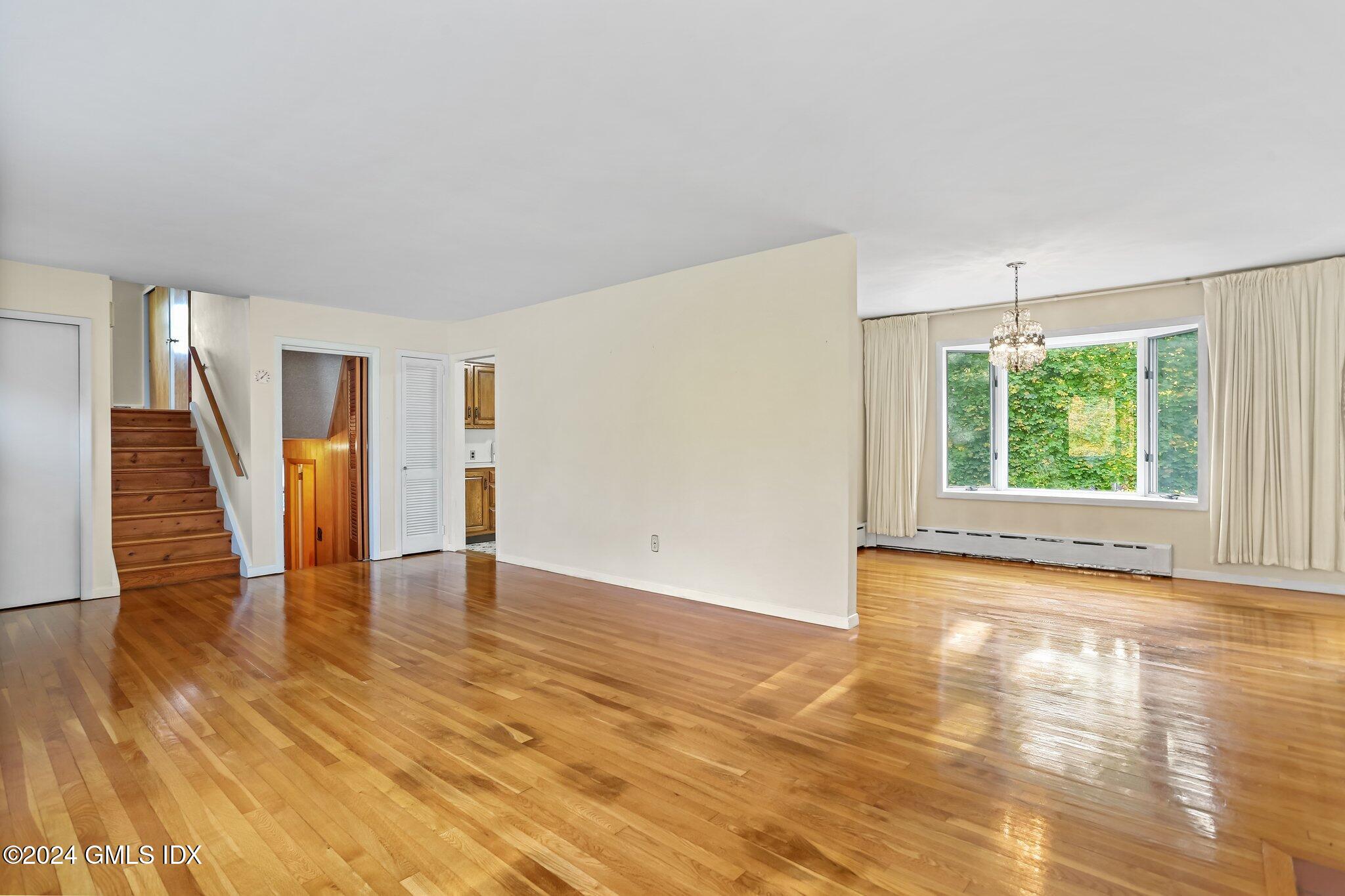 20 Norias Road Greenwich, CT 06830 - Photo 7 of 40 an empty room with wooden floor and windows