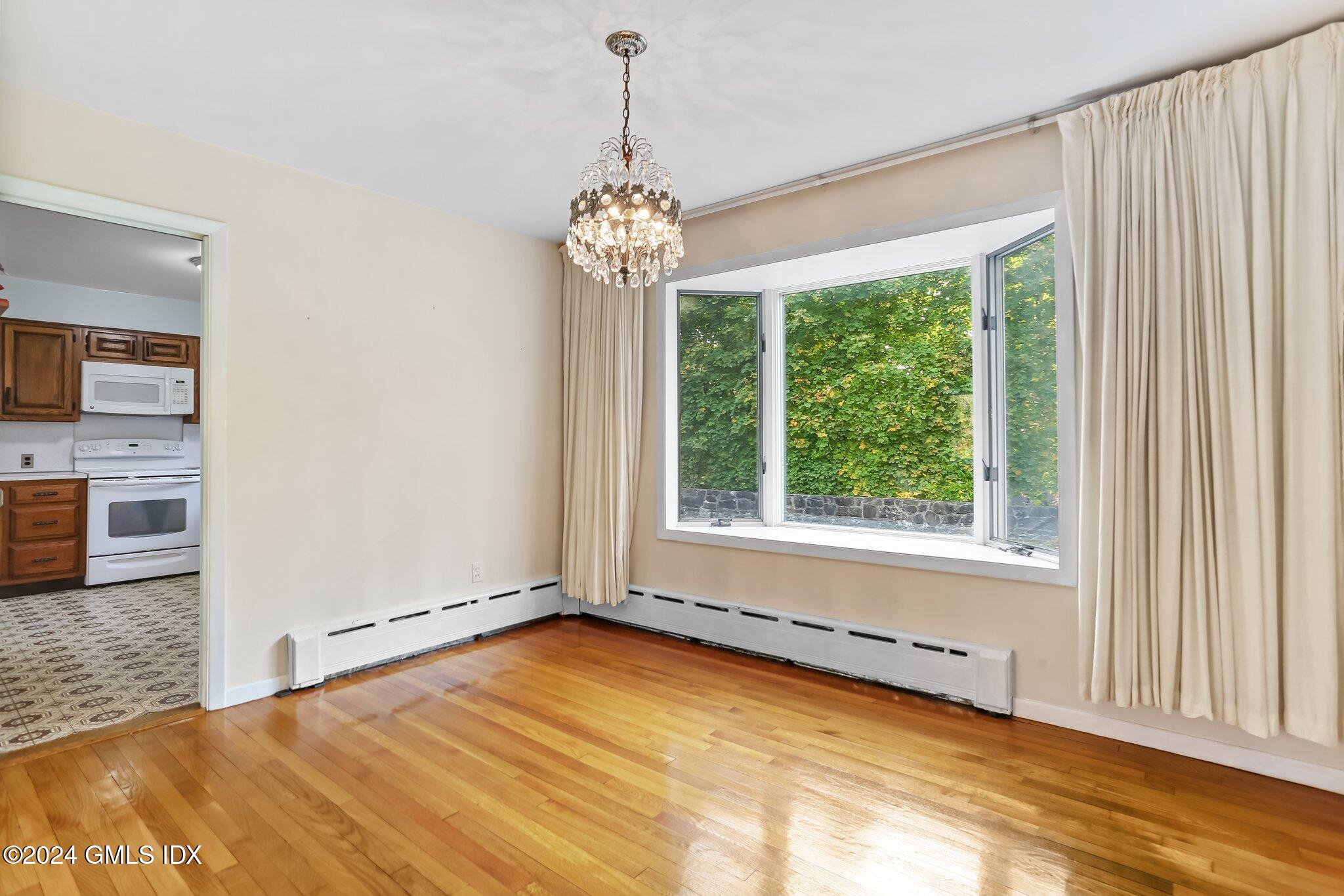 20 Norias Road Greenwich, CT 06830 - Photo 8 of 40 a view of an empty room with a window and a kitchen