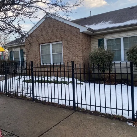 a view of a house with a wooden fence