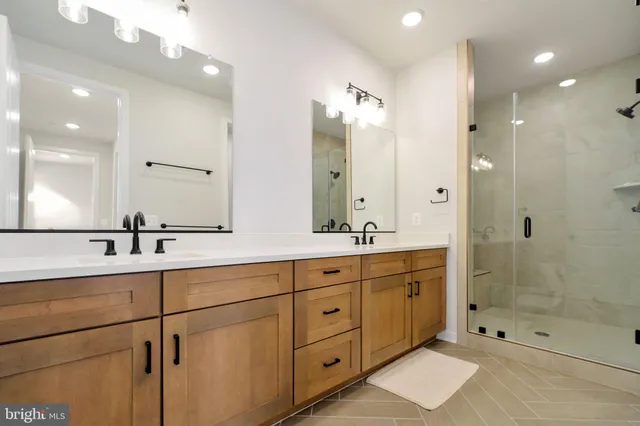 a bathroom with double sink and a mirror