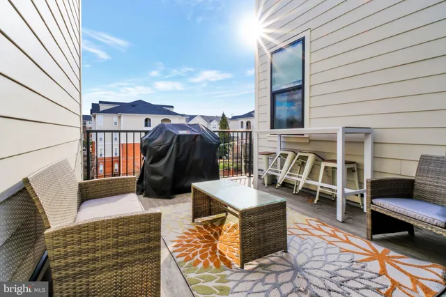 a roof deck with couch and chairs
