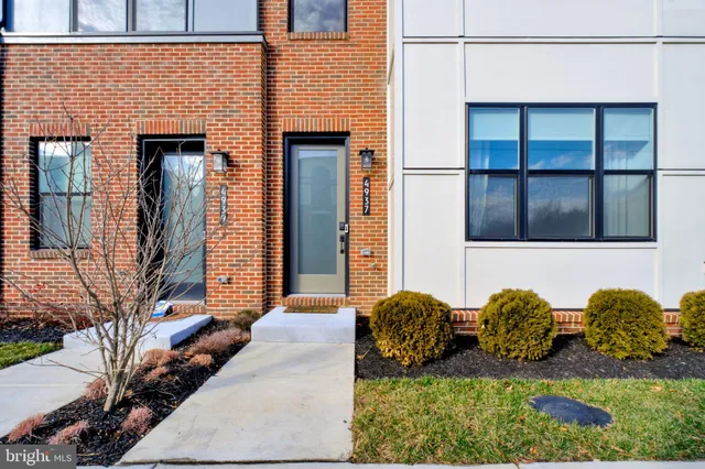 a view of two chairs in front of house