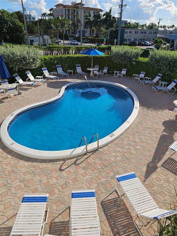 120 Northeast 20th Avenue, Unit 3 Deerfield Beach, FL 33441 - Photo 12 of 14 a view of a swimming pool with lounge chair
