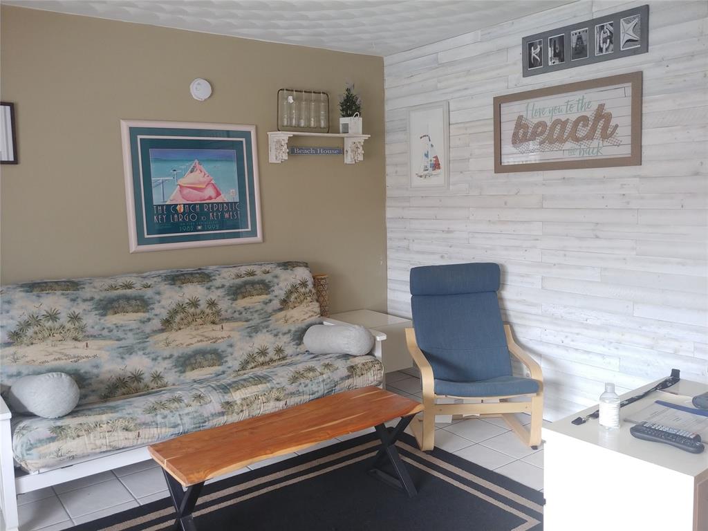 120 Northeast 20th Avenue, Unit 3 Deerfield Beach, FL 33441 - Photo 3 of 14 a living room with furniture and wall paintings