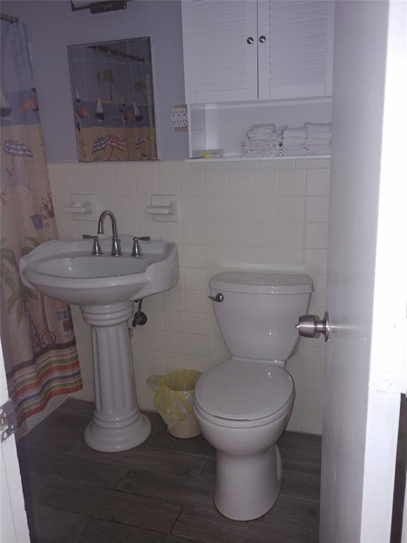 120 Northeast 20th Avenue, Unit 3 Deerfield Beach, FL 33441 - Photo 7 of 14 a bathroom with a toilet sink and mirror