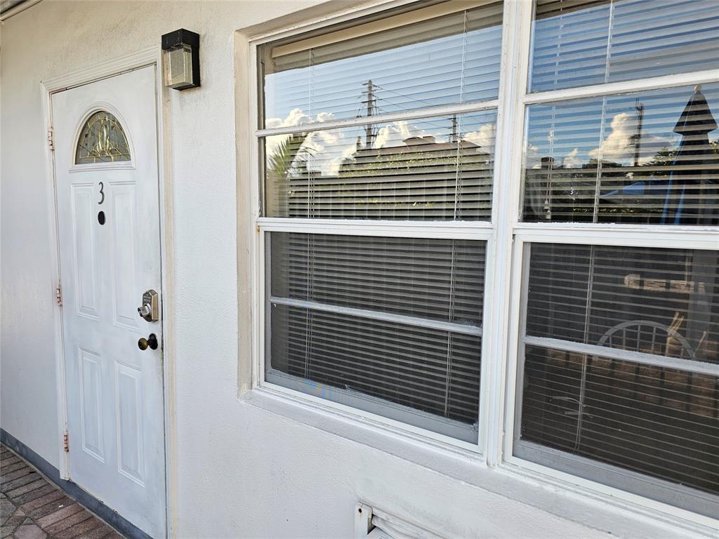120 Northeast 20th Avenue, Unit 3 Deerfield Beach, FL 33441 - Photo 8 of 14 a view of a door of a house with a window