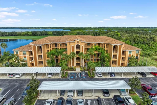 a living room with furniture a flat screen tv and a large window