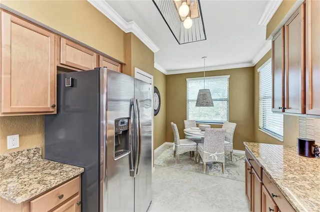 a large room with lots of tables a chandelier and couches