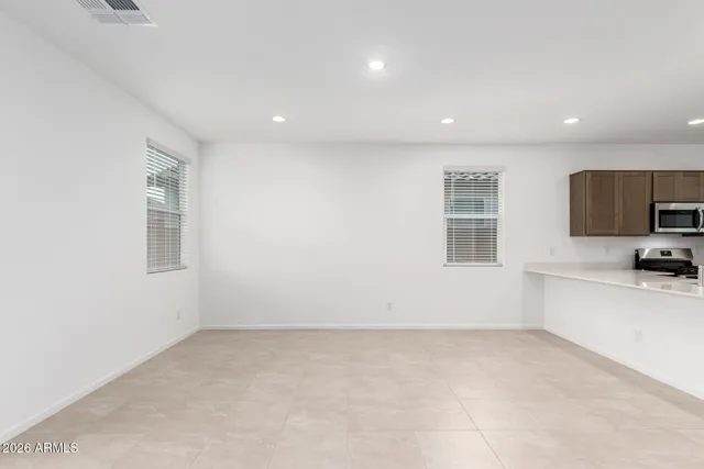a view of a livingroom with an empty space and a window