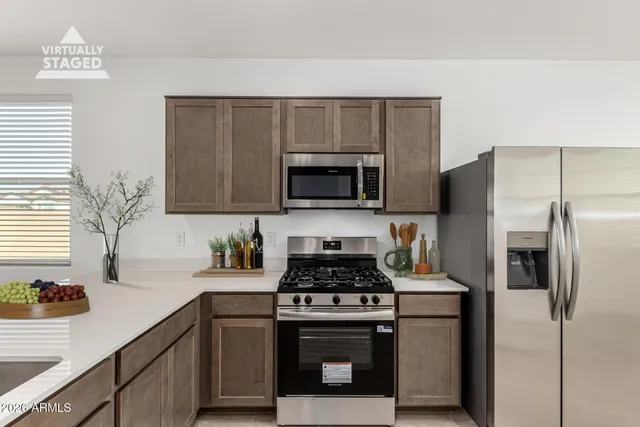 a kitchen with cabinets stainless steel appliances and counter space