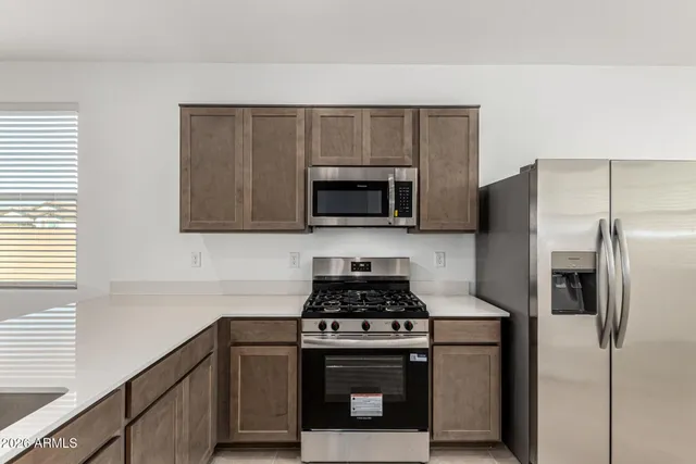a kitchen with a refrigerator stove and microwave