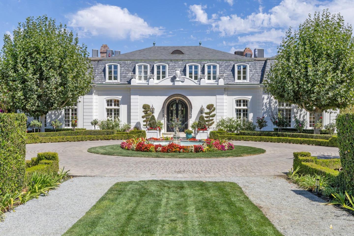a front view of a house with swimming pool having outdoor seating