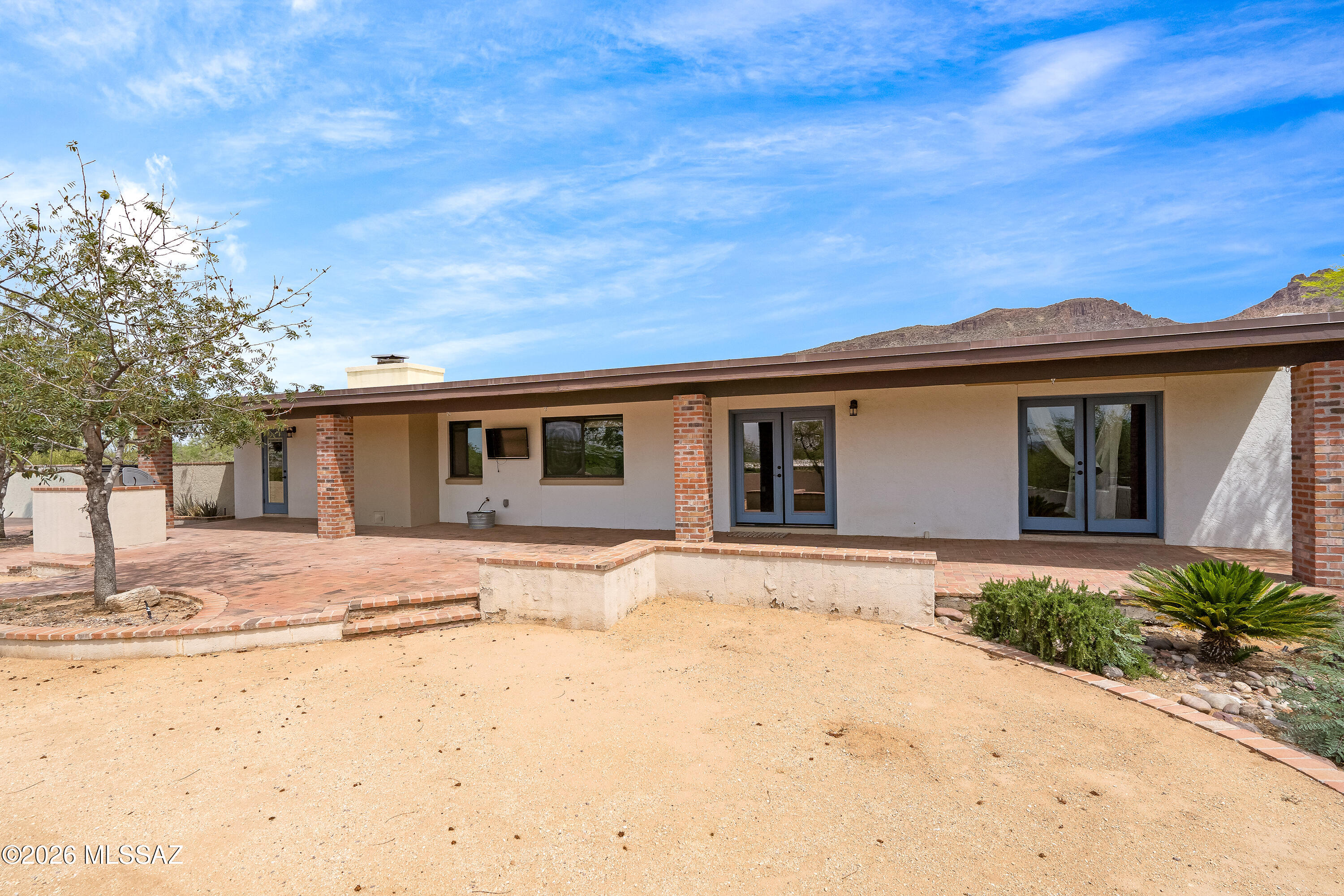 9420 East Ravine Trail Tucson, AZ 85749 - Photo 26 of 39 a front view of a house with a outdoor space