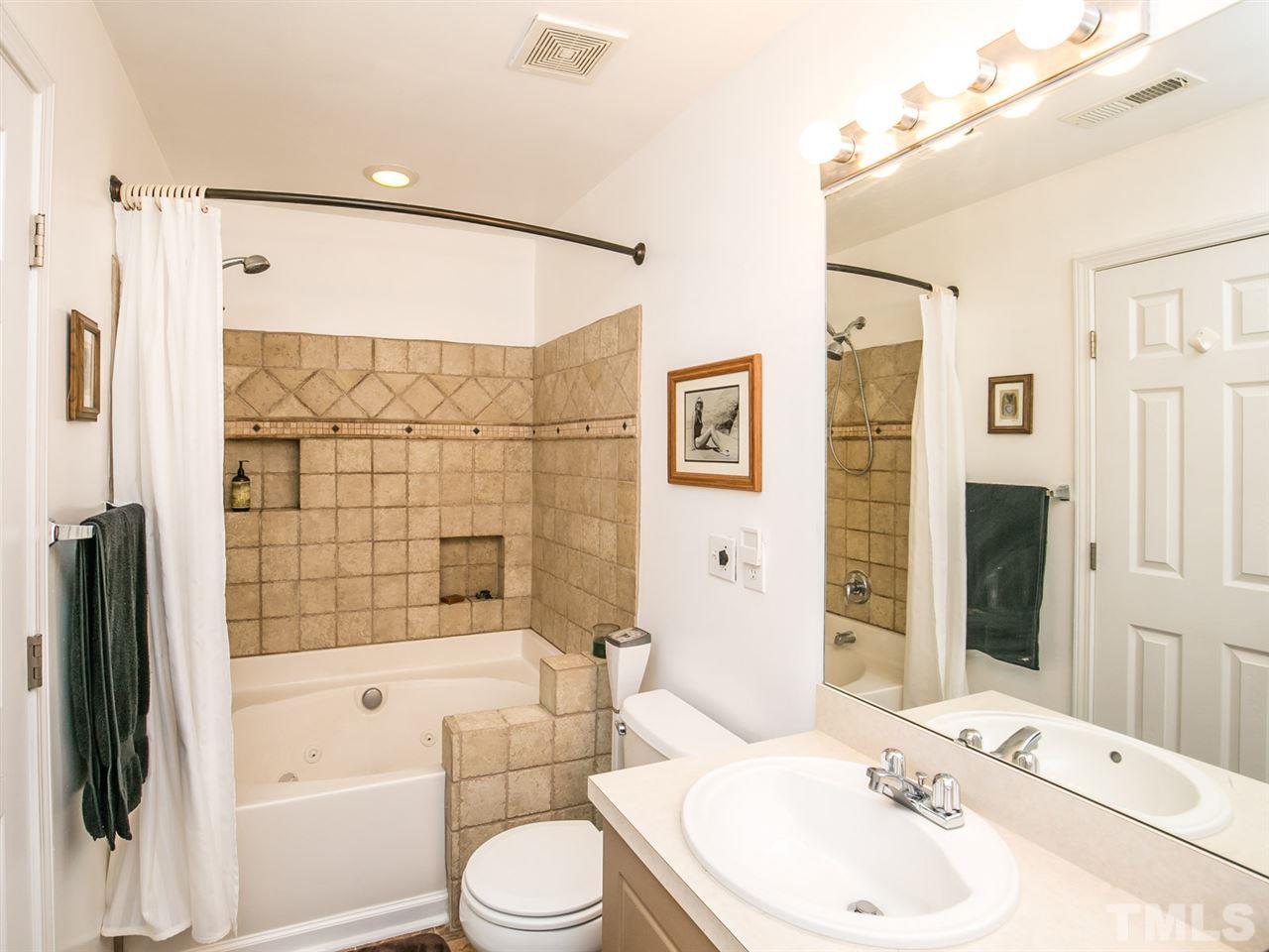 2128 Persimmon Ridge Drive Raleigh, NC 27604 - Photo 11 of 25 The jetted tub is a luxury rarely found in these townhouses and the updated tile just adds to the appeal.