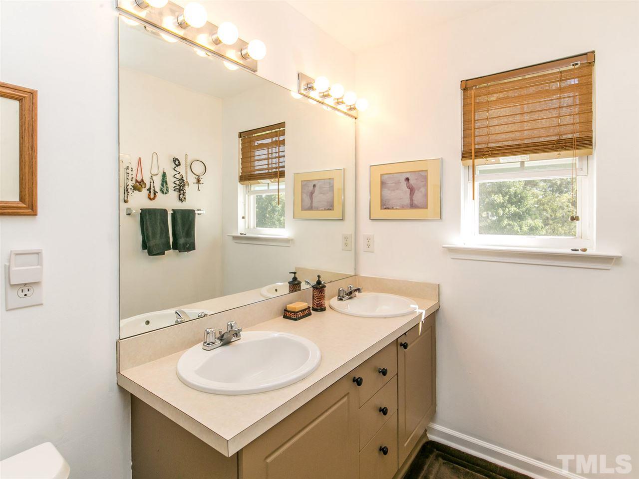 2128 Persimmon Ridge Drive Raleigh, NC 27604 - Photo 12 of 25 The large vanity has double sinks and updated faucets.