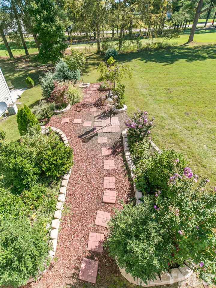 2128 Persimmon Ridge Drive Raleigh, NC 27604 - Photo 19 of 25 The seller has added planting beds and bushes increasing the privacy in the back of the home.
