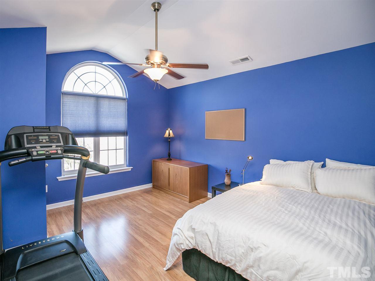 2128 Persimmon Ridge Drive Raleigh, NC 27604 - Photo 6 of 25 The front bedroom has a beautiful arch top window that captures the light and creates a brightly welcoming room.