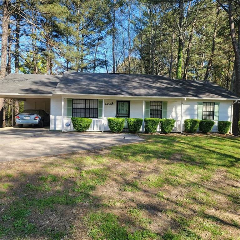 6454 West Fayetteville Road Riverdale, GA 30296 - Photo 1 of 1 a front view of a house with a yard and green space