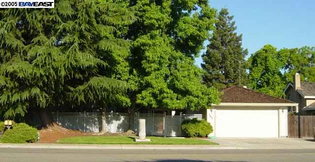 741 North Manley Road Ripon, CA 95366 - Photo 1 of 9 a white house with a yard and plants