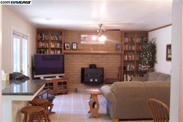 741 North Manley Road Ripon, CA 95366 - Photo 5 of 9 a living room with furniture a flat screen tv and a fireplace