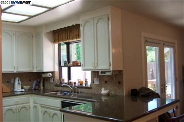 741 North Manley Road Ripon, CA 95366 - Photo 6 of 9 a kitchen with sink a window and cabinets
