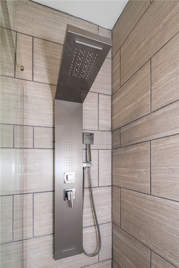 1217 Jasper Road Xenia, OH 45385 - Photo 40 of 62 This modern shower features elegant tile work and a sleek, sophisticated multi-function shower system.
