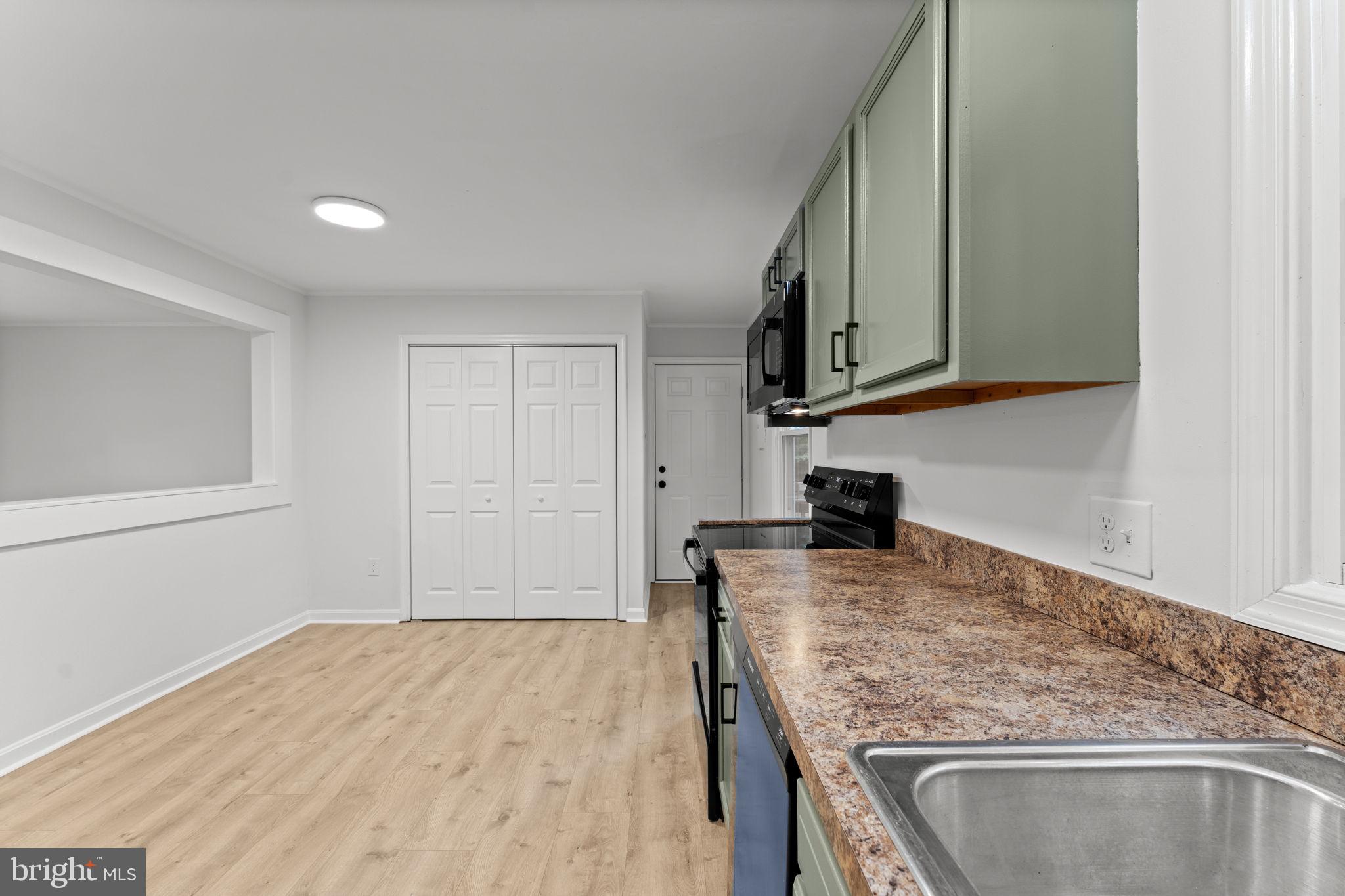 1821 James City Road Reva, VA 22735 - Photo 20 of 44 a kitchen with granite countertop a sink and a stove top oven