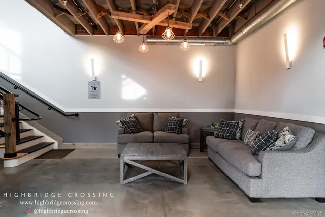 a living room with furniture and stairs