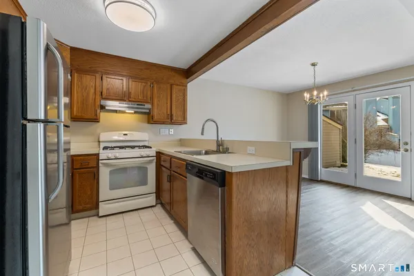 a kitchen with a sink stove and refrigerator