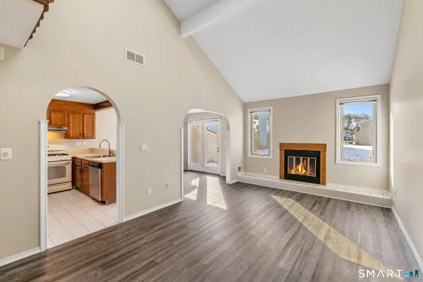 an empty room with a fireplace and wooden floor