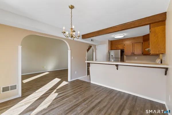 a view of a kitchen with a sink and wooden floor